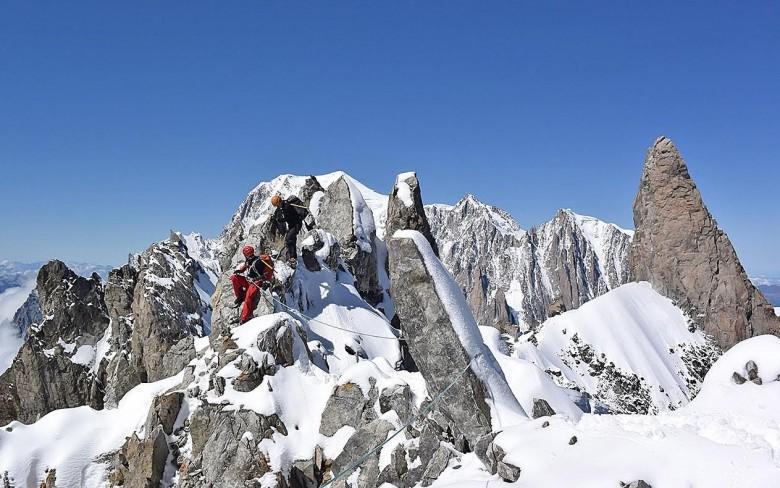 Traversing the summit of the Aiguille du Rochefort via the Rochefort arete with the Dent du Geant and Mont Blanc in the background